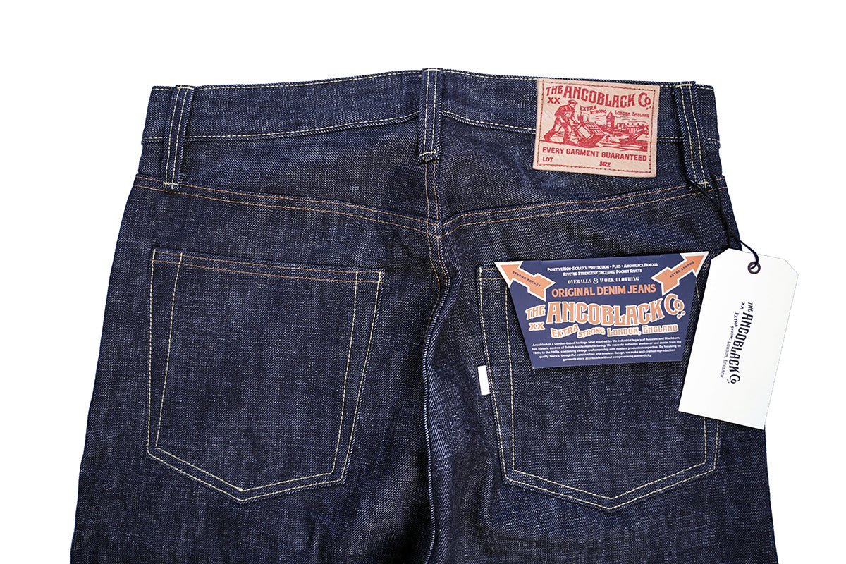 Ancoblack pocket detail showing brand white tab and vintage pocket flasher tag on raw denim